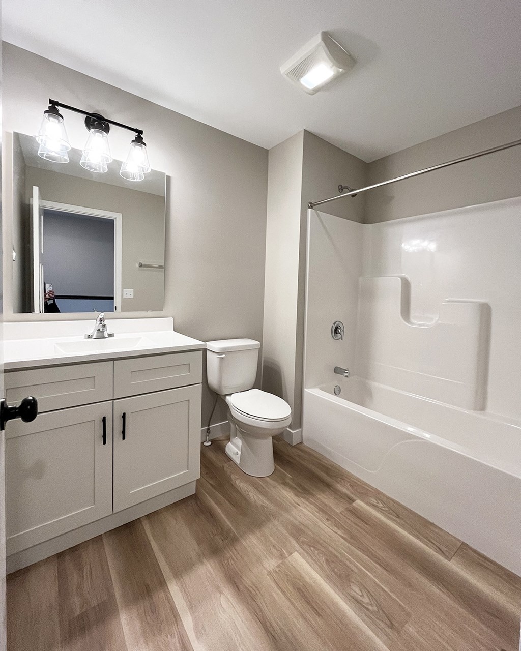 a bathroom with a toilet and a shower and a sink