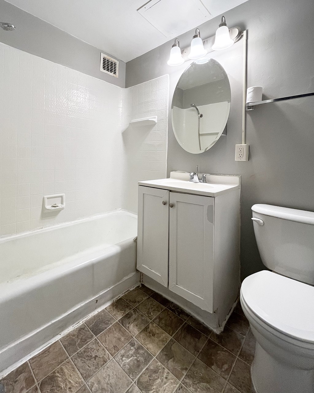 a bathroom with a toilet sink and bath tub