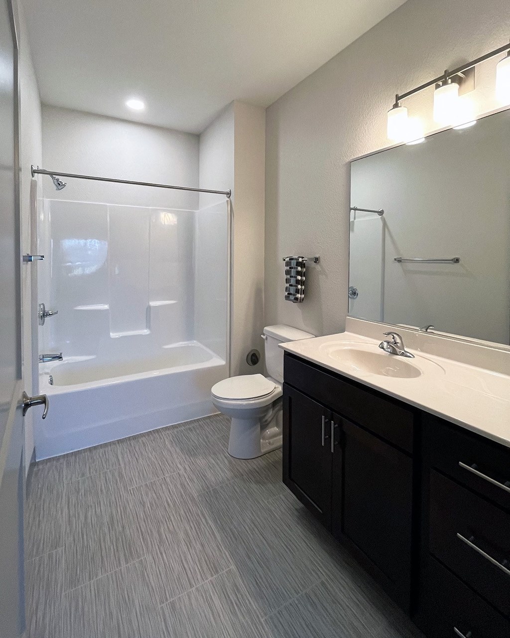 a bathroom with a shower toilet sink and mirror