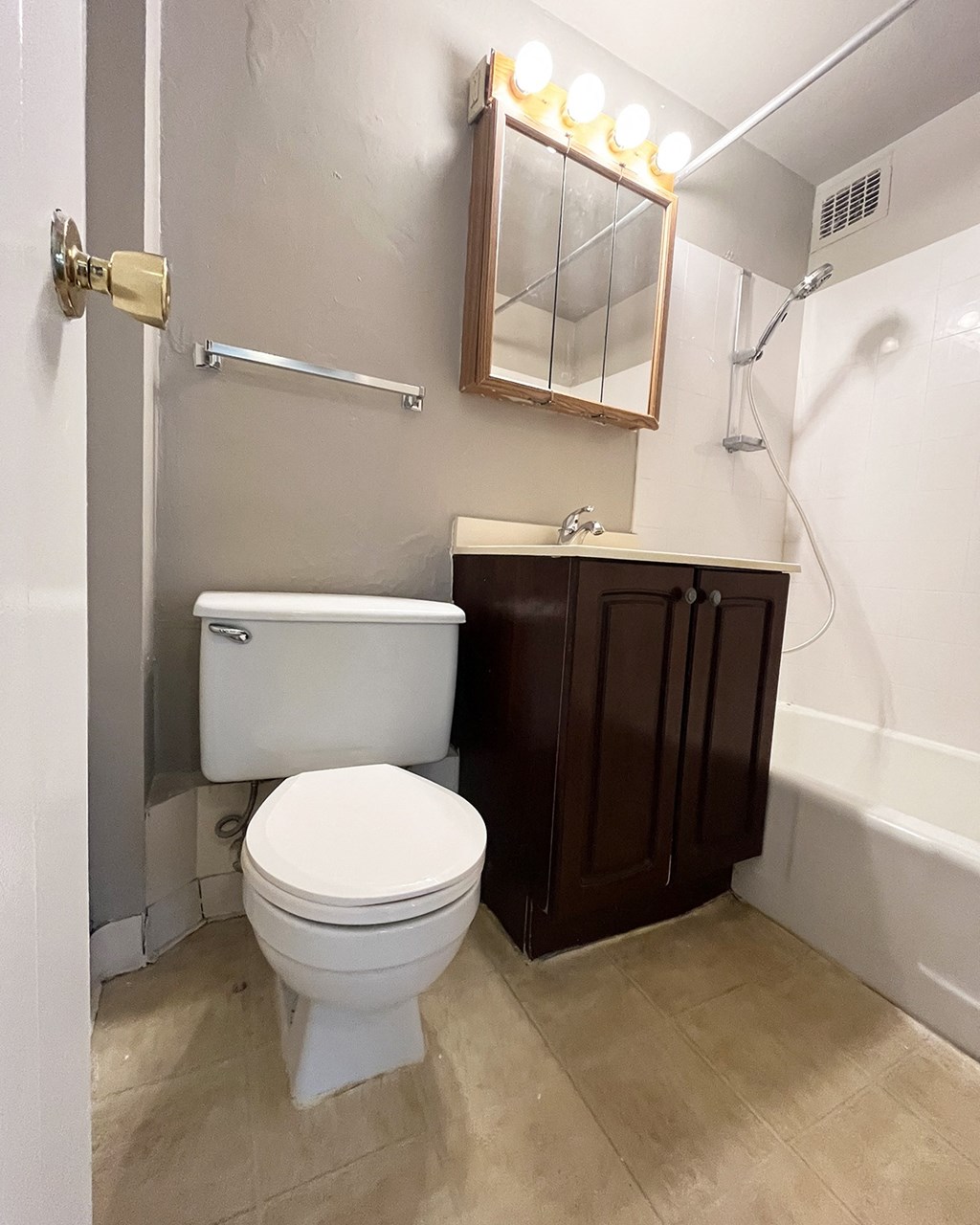 a bathroom with a toilet and a sink and a bath tub