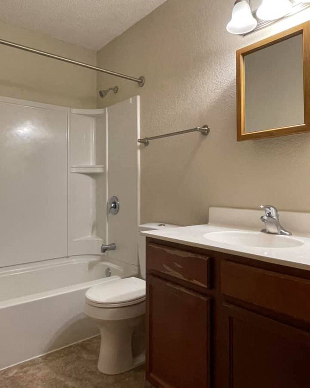 a bathroom with a toilet and a sink and a shower