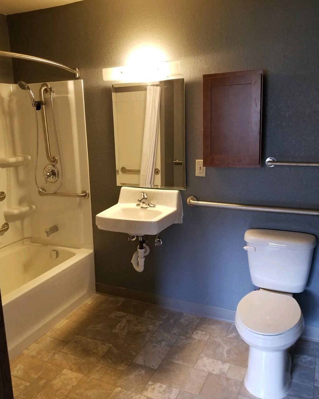 a bathroom with a toilet sink and a shower
