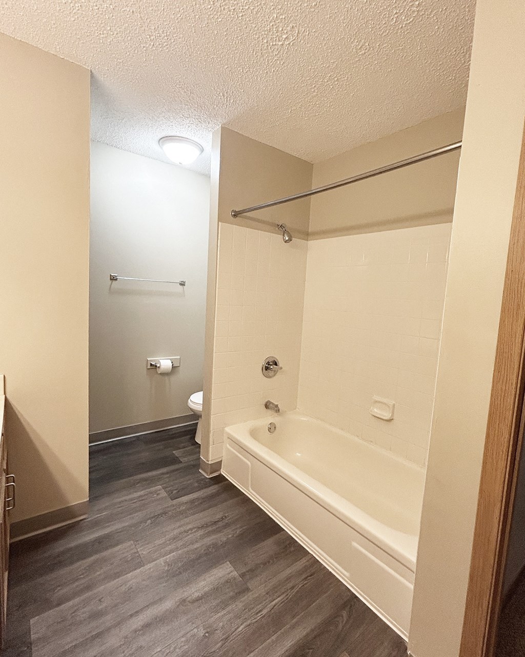 A white bathroom with a toilet, sink, and bathtub.