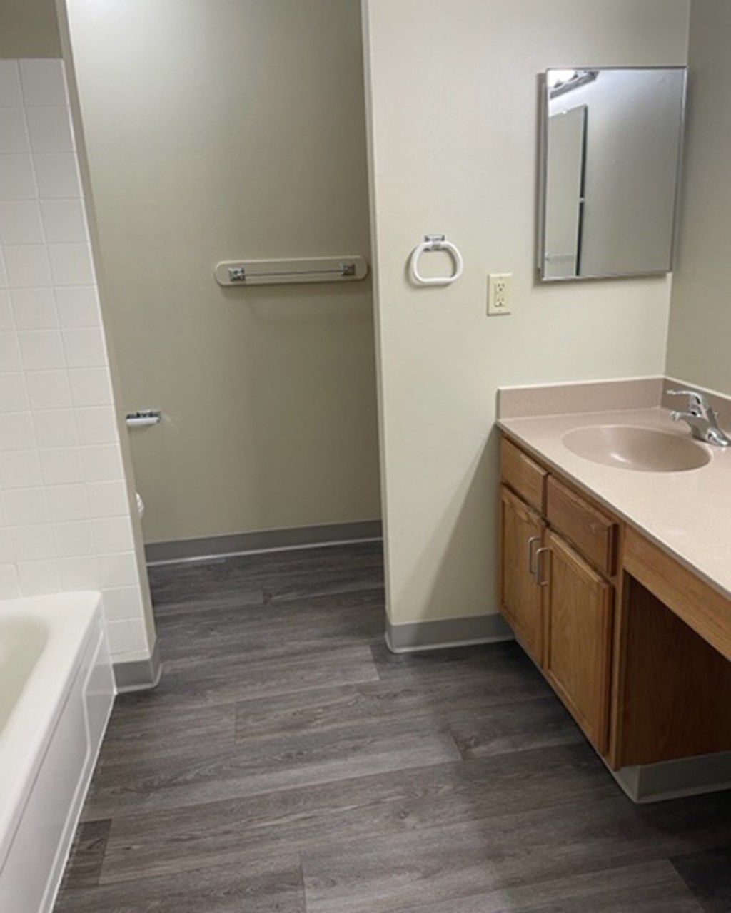 a bathroom with a sink and a tub and a mirror