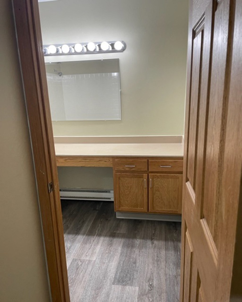 a room with a desk and a mirror