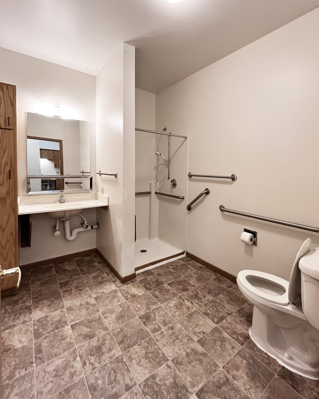 A bathroom with a toilet, sink, and shower.