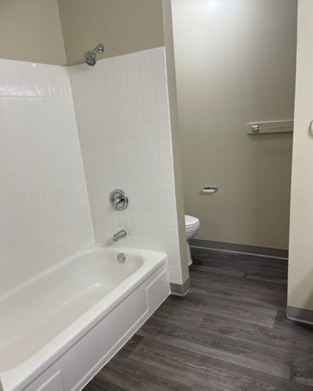 a bathroom with a tub and a toilet in it