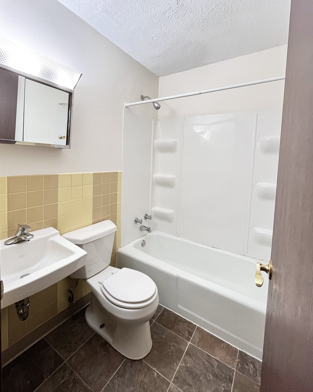 A white toilet sits next to a sink in a bathroom.