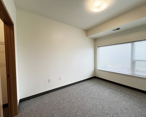 A room with a window and a door.