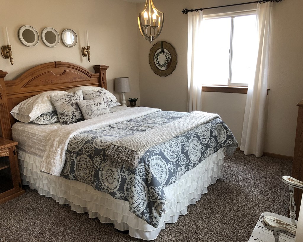 a bedroom with a bed and a window