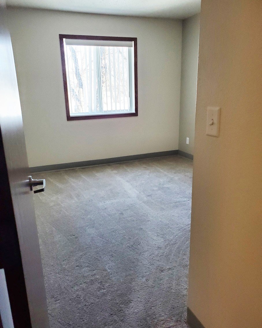 an empty room in a house with a window