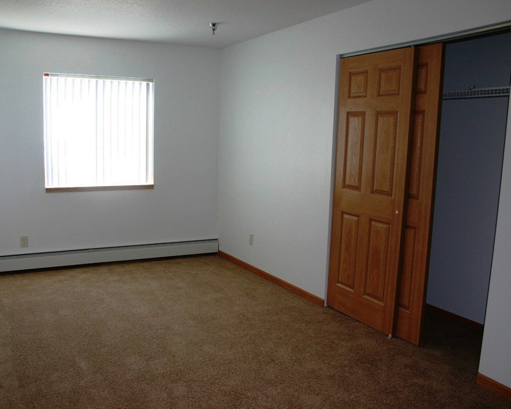 an empty room with a door and a window