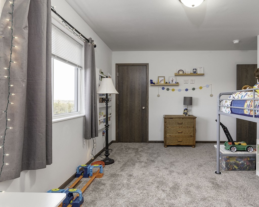 a childrens bedroom with a bunk bed and a window