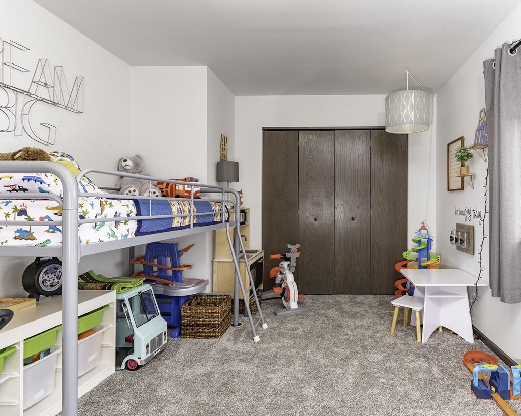 a childrens bedroom with bunk beds and a closet