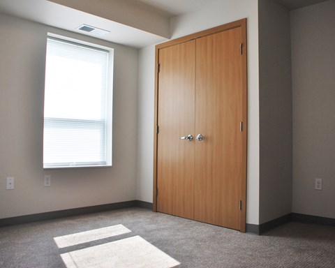 an empty room with a door and a window