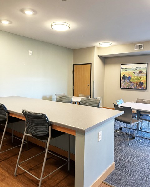 a room with a long table and chairs and a door