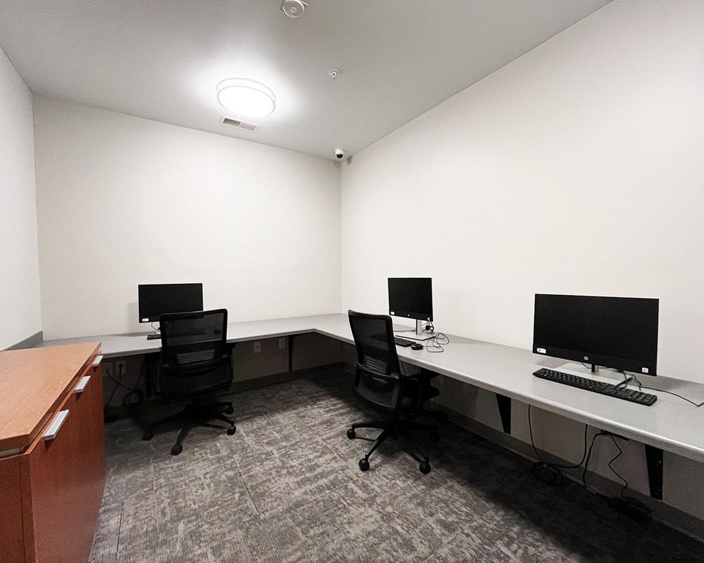 A room with two desks and two chairs.