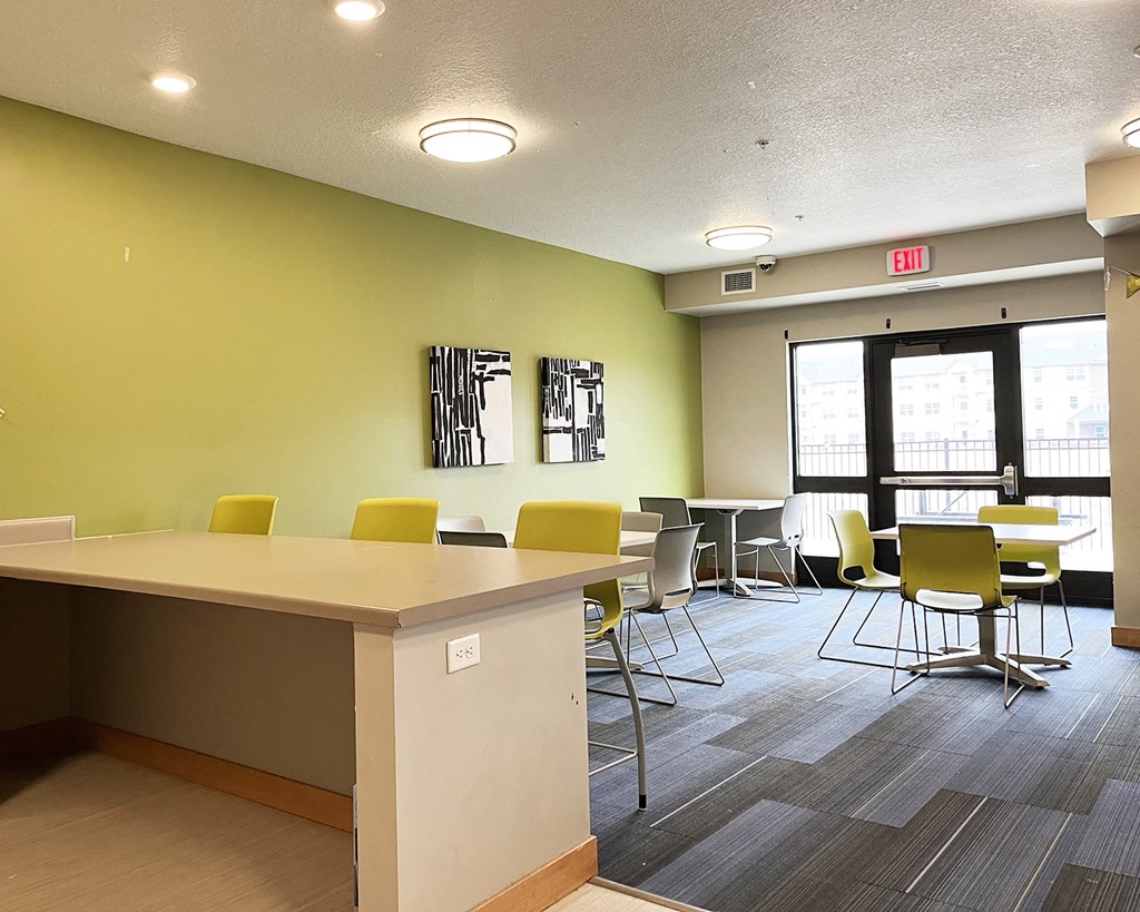 A conference room with a long table and chairs.