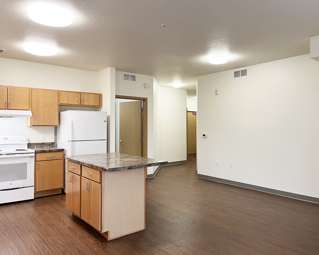 A kitchen with wooden cabinets and a white refrigerator.