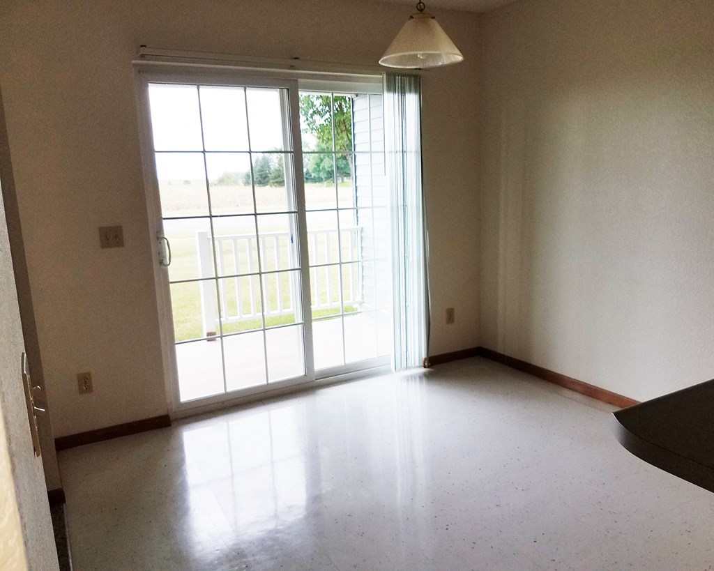 an empty living room with sliding glass doors