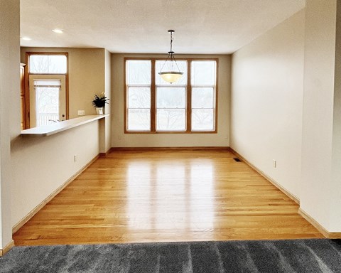 A room with wooden floors and a large window.
