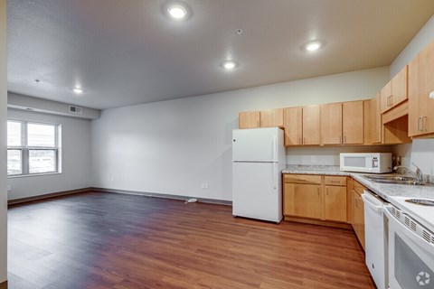 A kitchen with wooden cabinets and a white refrigerator.