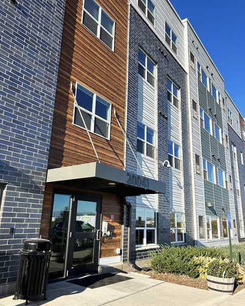 a brick building with a glass door and a brown and gray facade