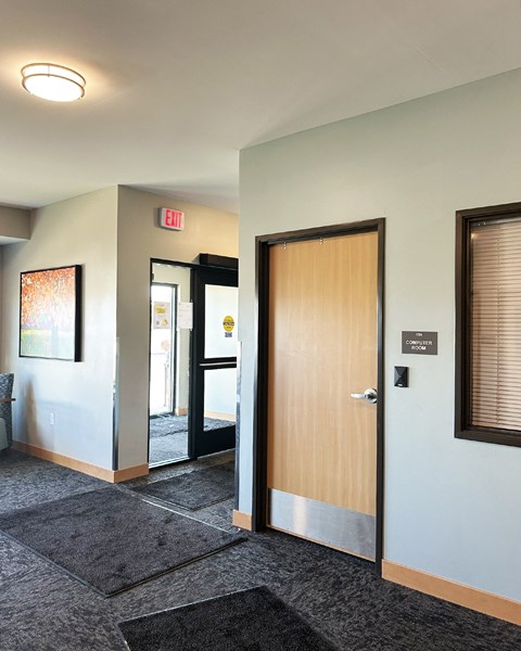 an open door in a lobby of an office building