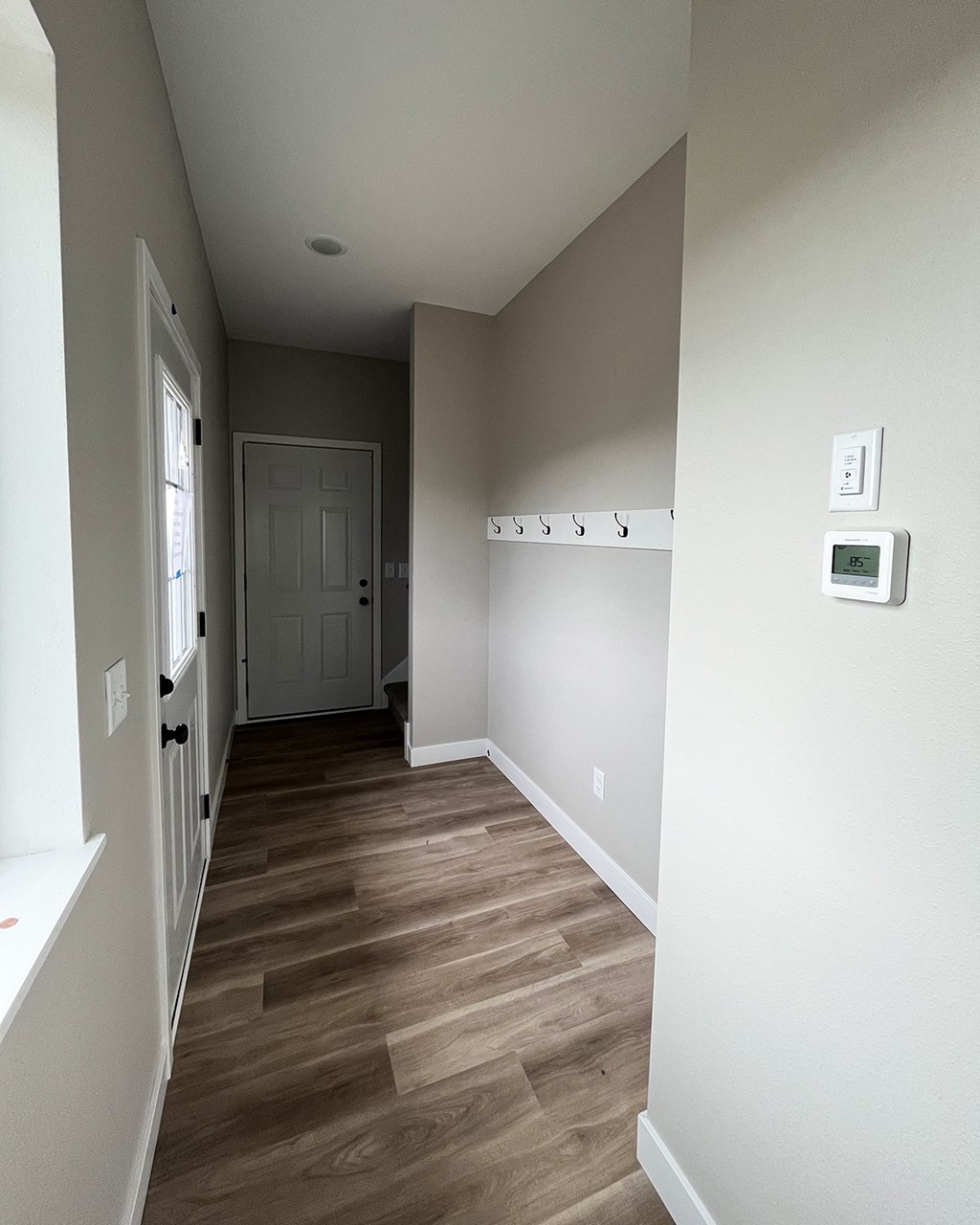 a bedroom with a medium sized closet and hardwood floors