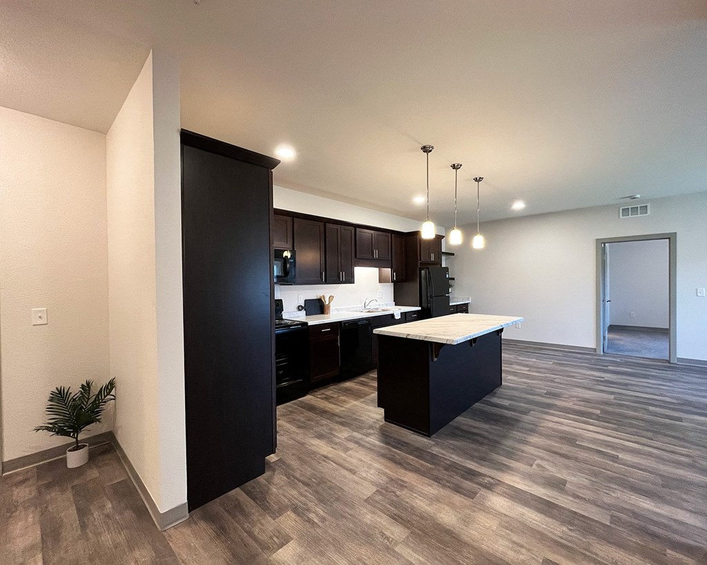 an open kitchen and living room with a large island