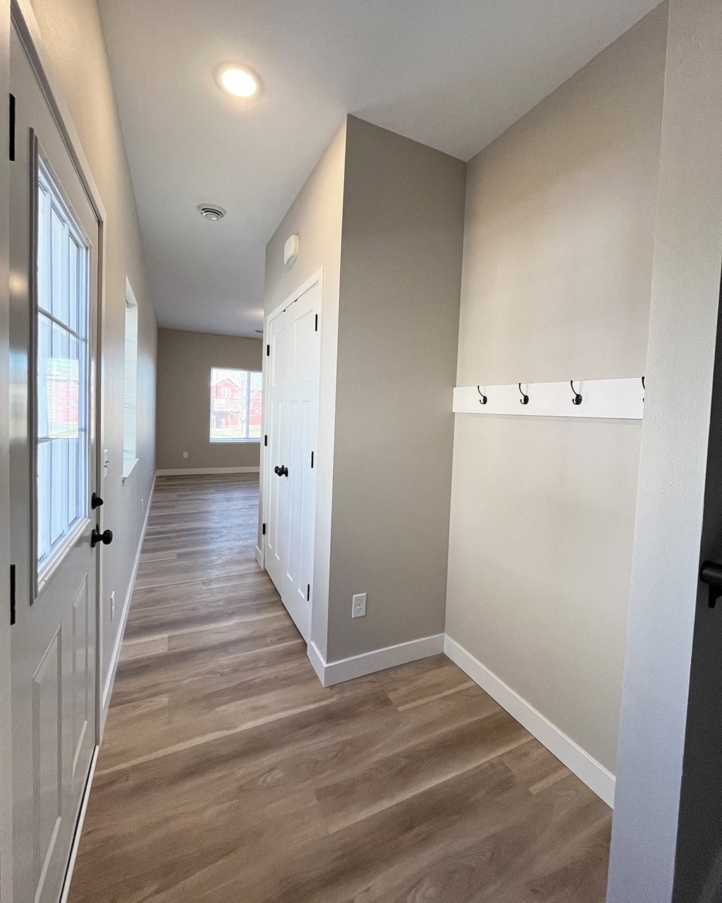 a view of the hallway from the front door of a new home