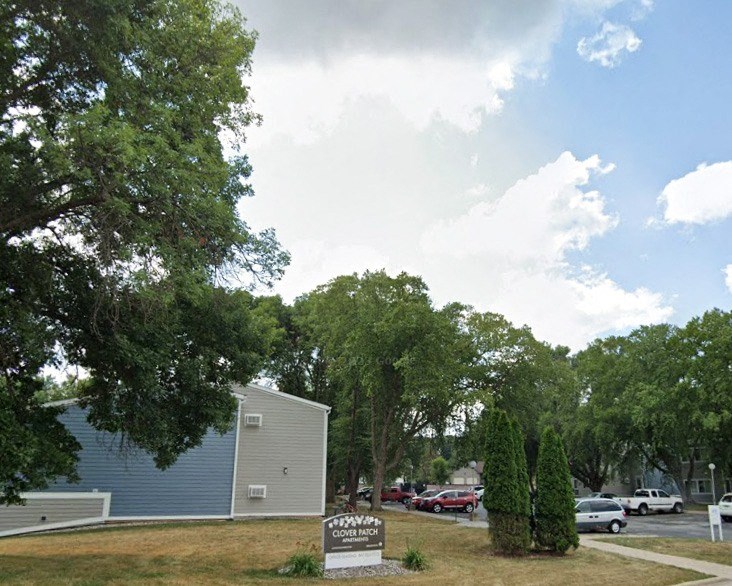 a parking lot with a sign in front of a building