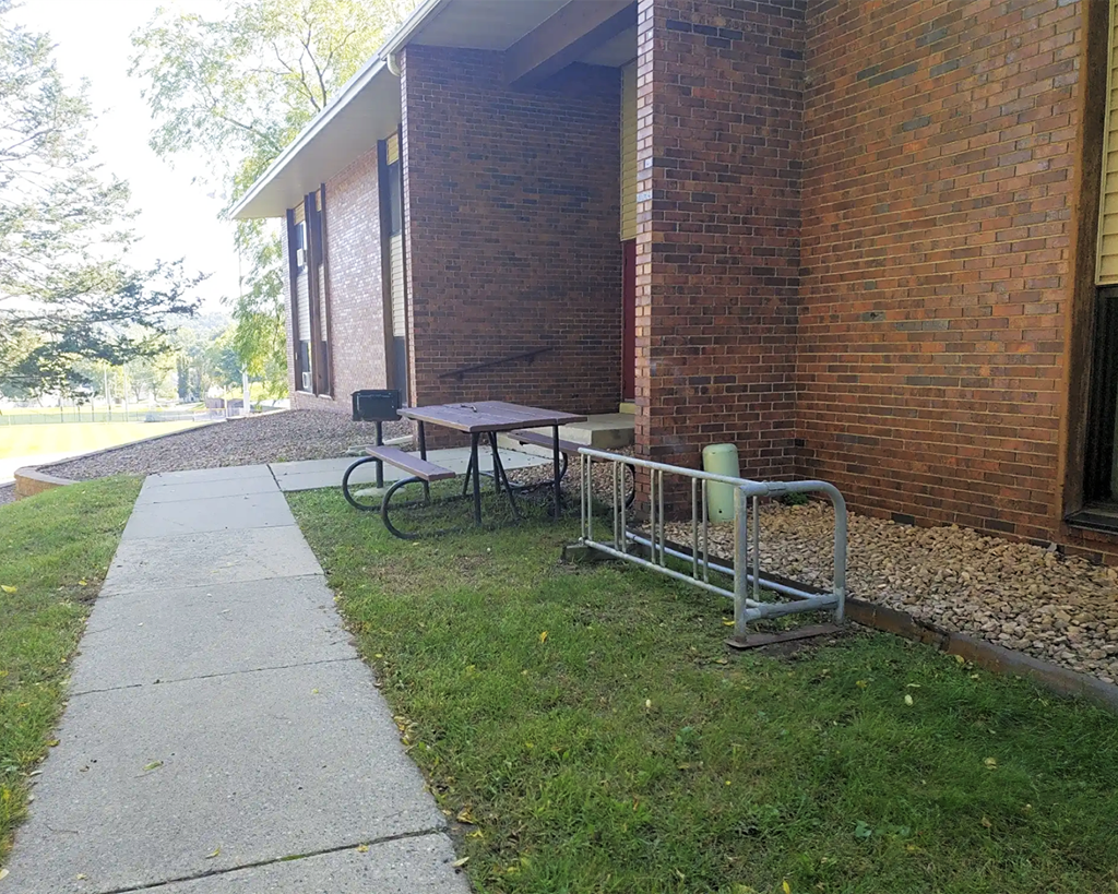 A brick building with a picnic table outside.