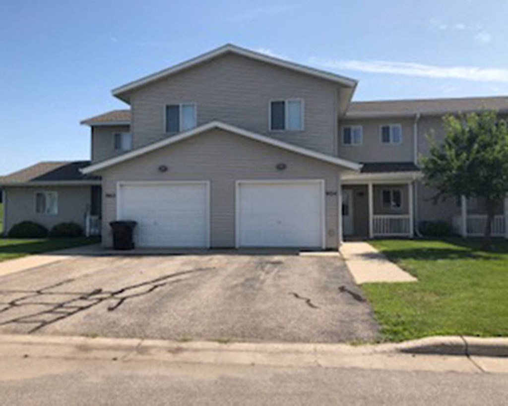 a house with two garage doors and a driveway