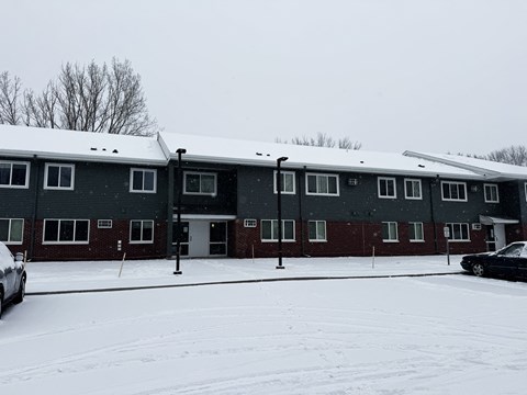 A building with a black car parked in front of it.