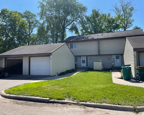 a white house with a lawn in front of it