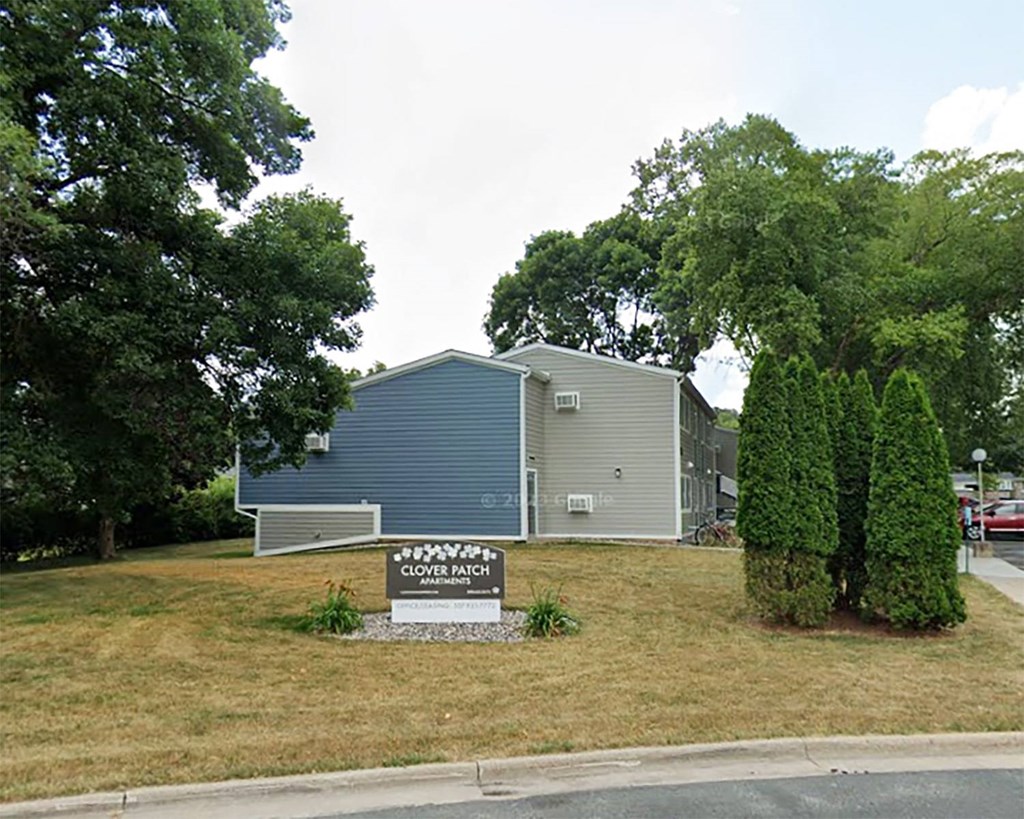 a property with a sign in front of a house