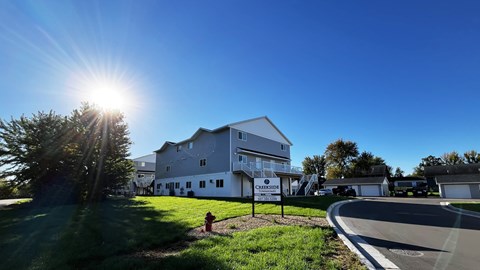 A large white building with the word "Circulation" on it is surrounded by a grassy area and trees.