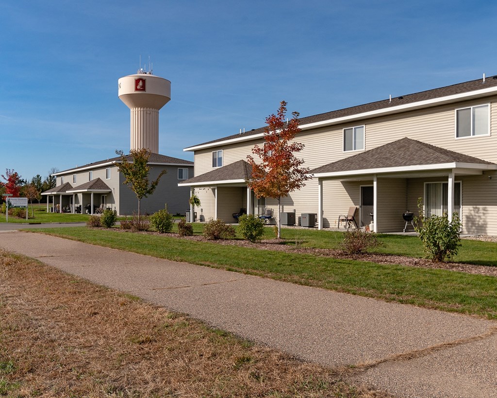 a row of houses with a water tower in the background