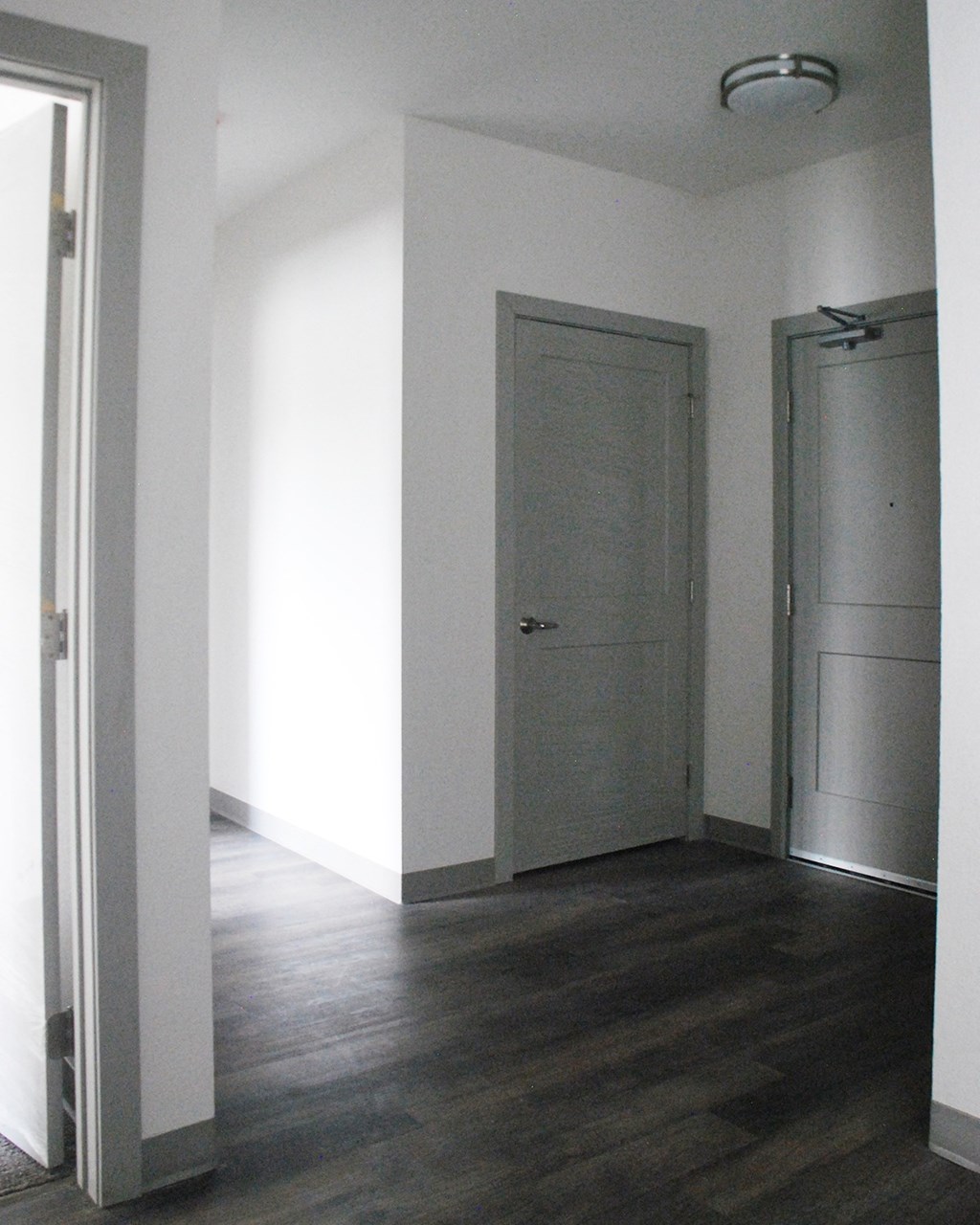 an empty room with a door open and a light shining on it