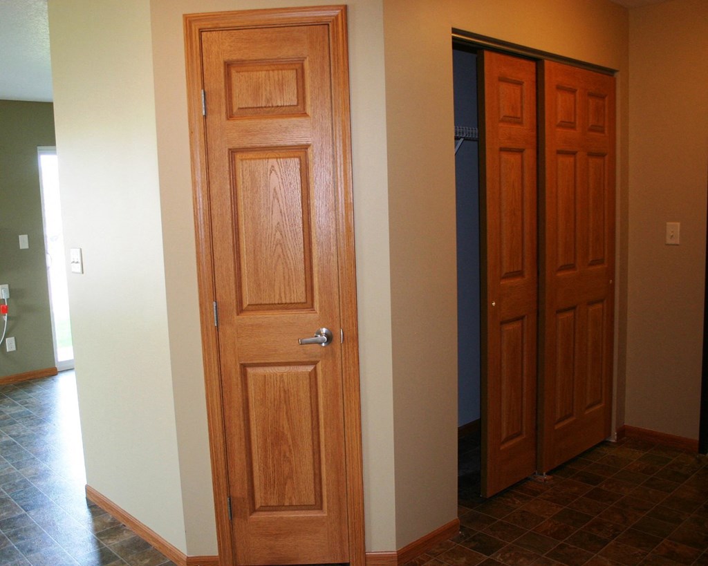 the closet and the bathroom door are next to each other