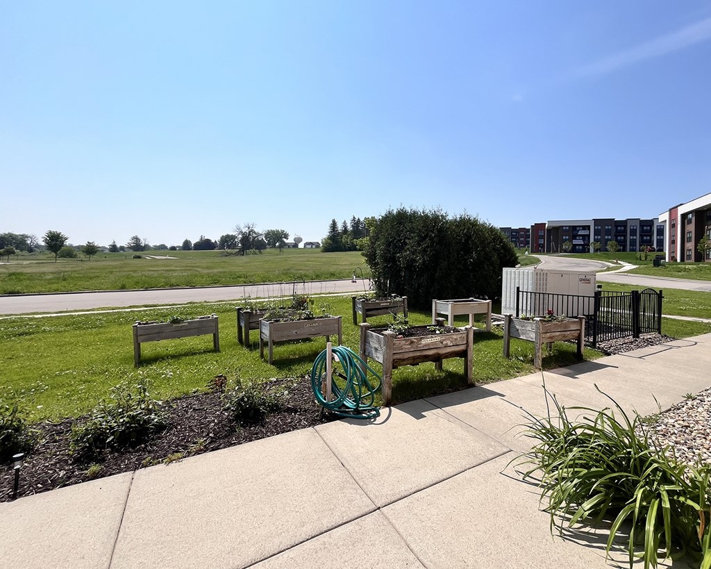 A playground with a green hose and a bench.