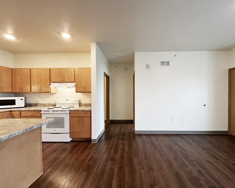 A kitchen with wooden cabinets and a white stove top oven.