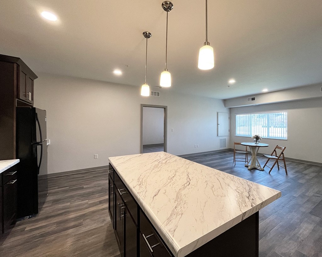 a kitchen with a large island in the middle of a living room