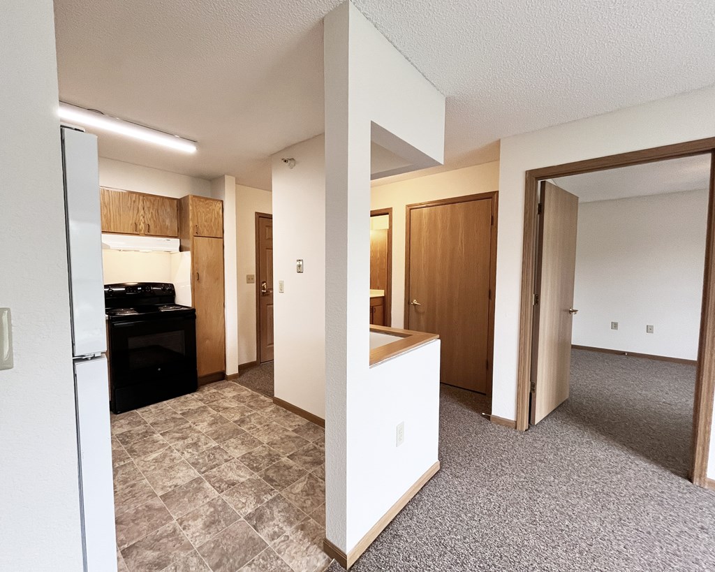 A kitchen area with a refrigerator, oven, and microwave.