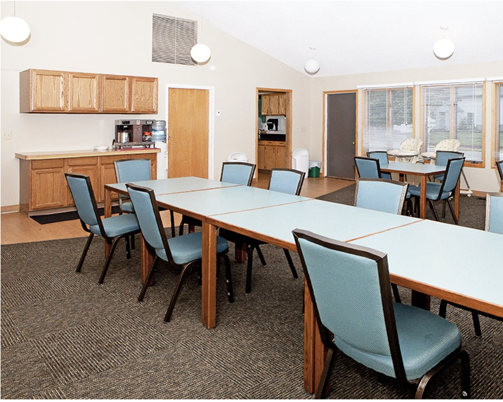 A conference room with a long table and chairs.