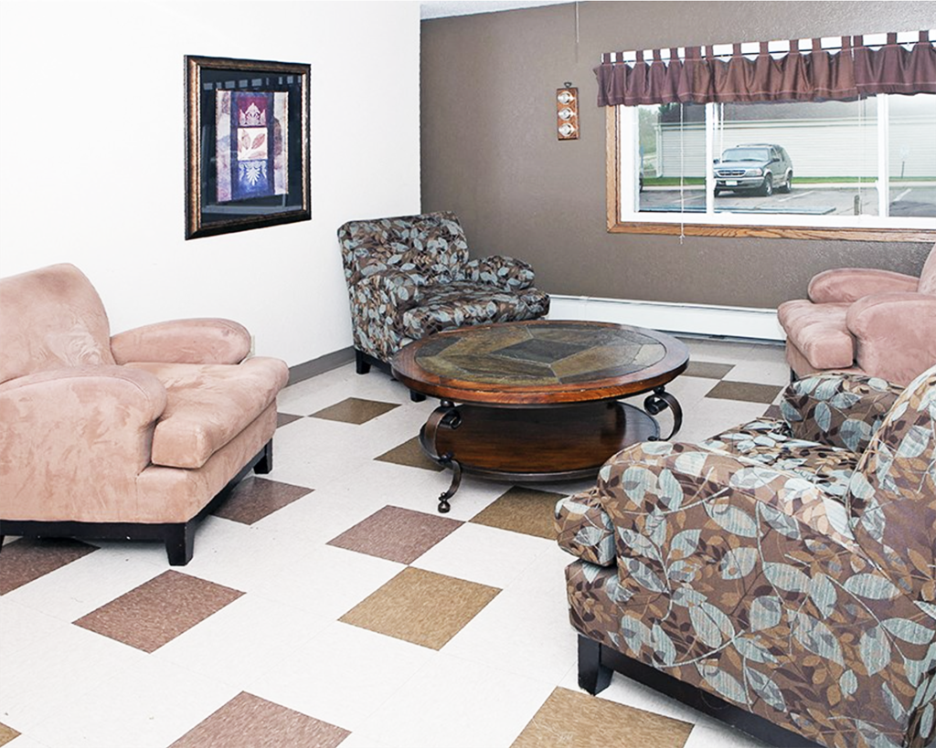 A living room with a brown and white checkered floor.