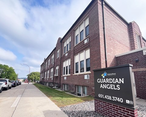 A brick building with a sign that says Guardian Angels.