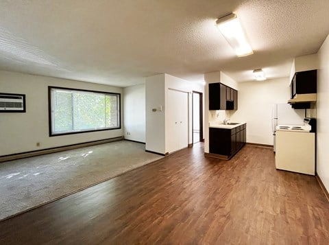 A room with wooden floors and white walls.