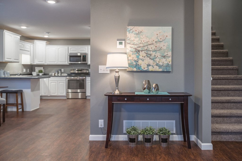 a living room with a fireplace and a table with potted plants